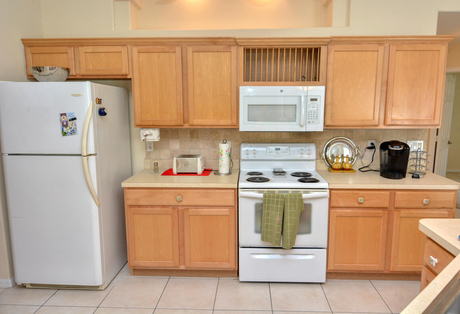 2041 Southwest Villanova Road Port St. Lucie, FL 34953 - Photo 16 of 42 a kitchen with a refrigerator sink and cabinets