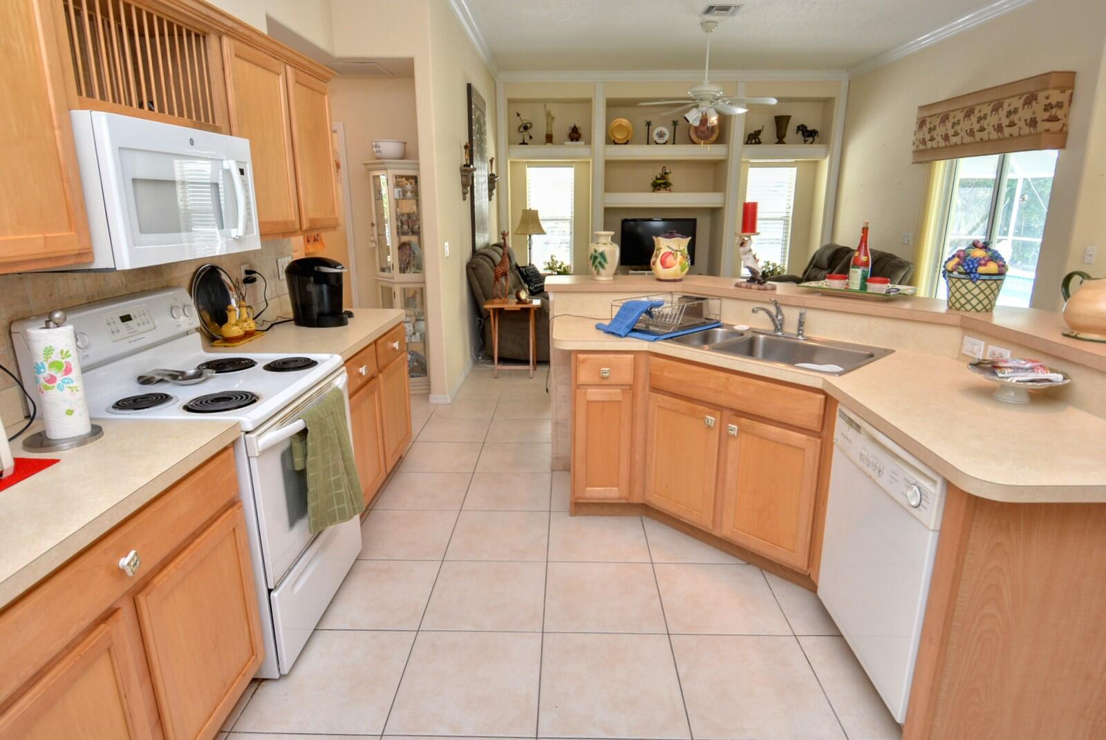 2041 Southwest Villanova Road Port St. Lucie, FL 34953 - Photo 17 of 42 a kitchen with a sink stove and refrigerator