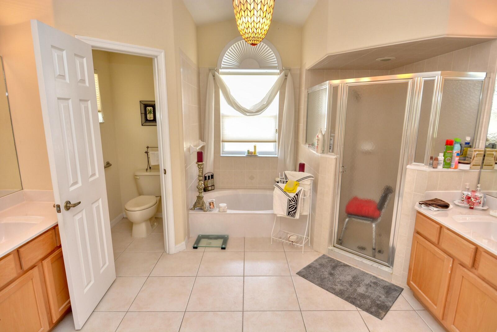 2041 Southwest Villanova Road Port St. Lucie, FL 34953 - Photo 21 of 42 a bathroom with a sink a toilet and shower
