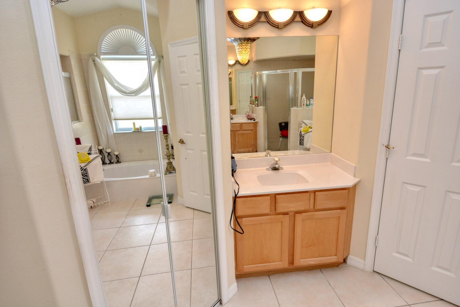 2041 Southwest Villanova Road Port St. Lucie, FL 34953 - Photo 24 of 42 a bathroom with a sink a vanity and a mirror
