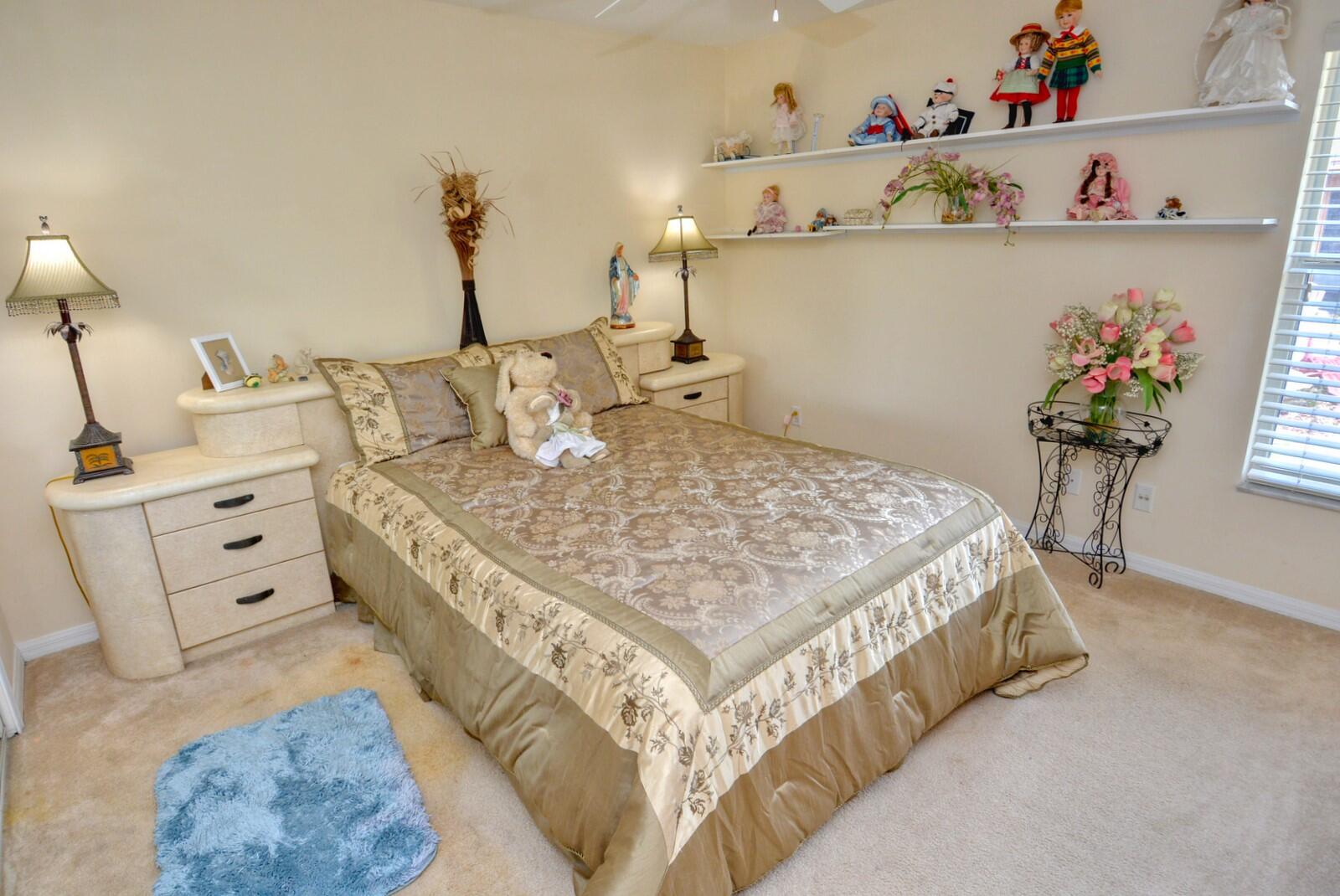2041 Southwest Villanova Road Port St. Lucie, FL 34953 - Photo 26 of 42 a bed sitting in a bedroom next to a window