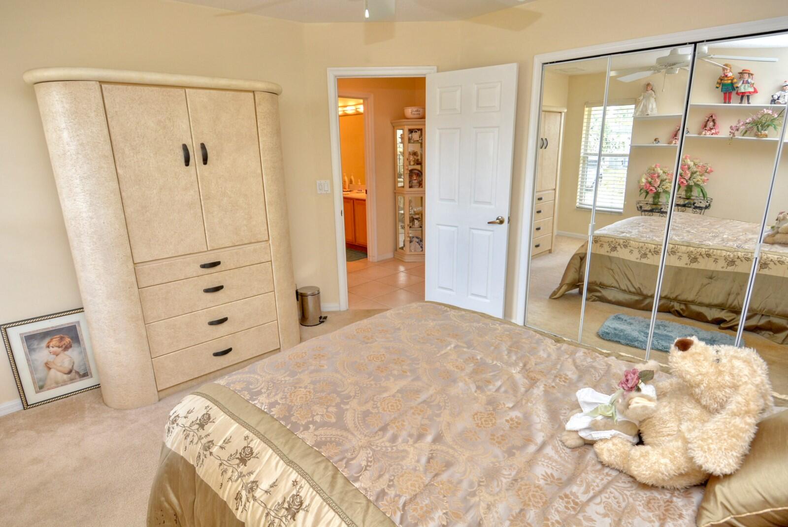 2041 Southwest Villanova Road Port St. Lucie, FL 34953 - Photo 27 of 42 a bedroom with a bed and cabinets