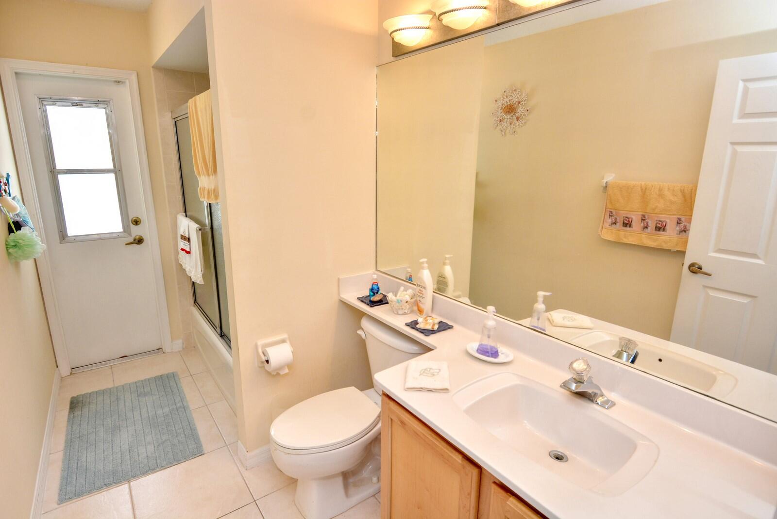 2041 Southwest Villanova Road Port St. Lucie, FL 34953 - Photo 30 of 42 a bathroom with a sink toilet and shower