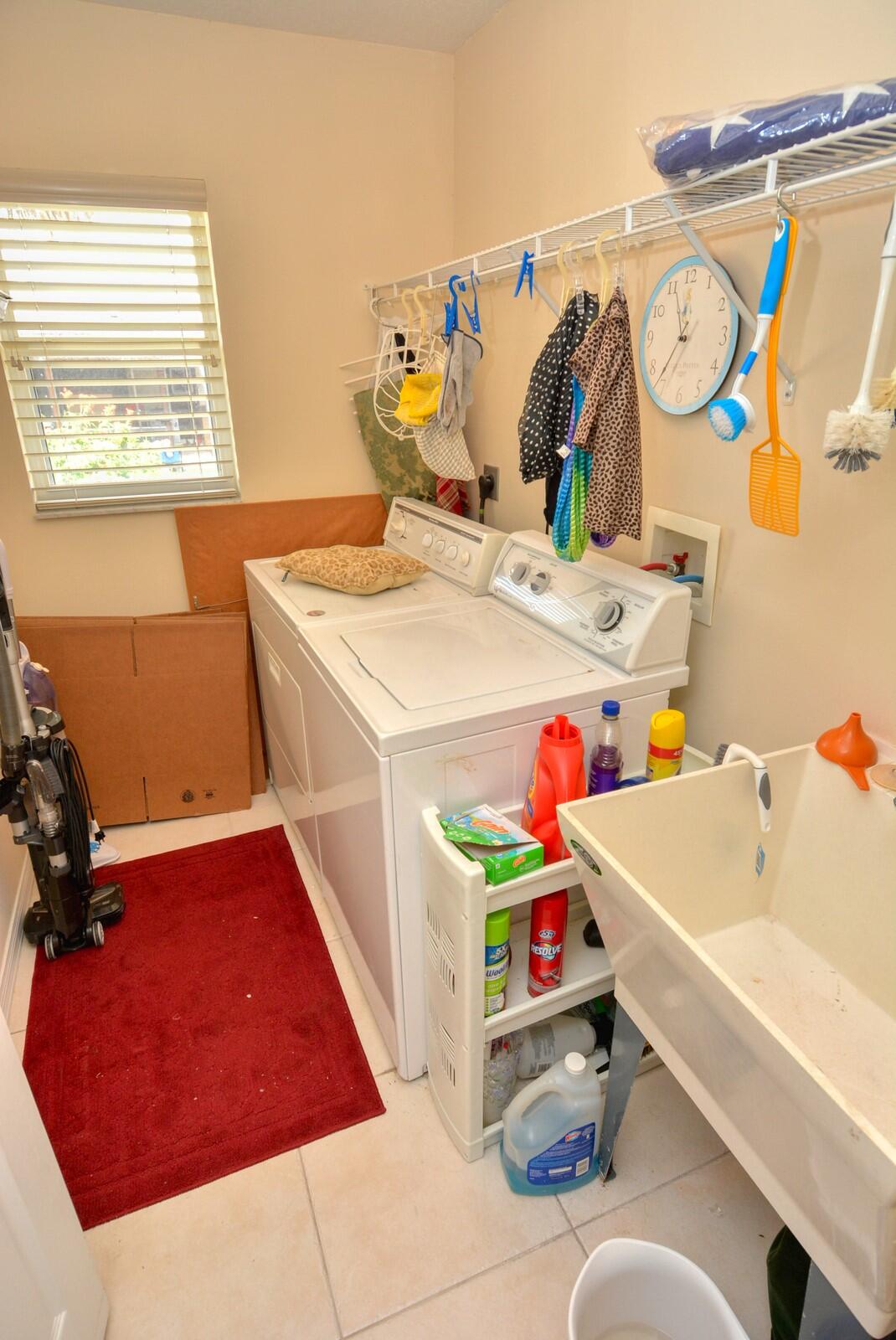 2041 Southwest Villanova Road Port St. Lucie, FL 34953 - Photo 32 of 42 a utility room with dryer and washer