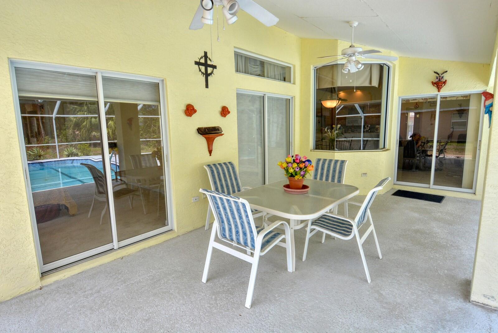 2041 Southwest Villanova Road Port St. Lucie, FL 34953 - Photo 33 of 42 a dining area with furniture and a window