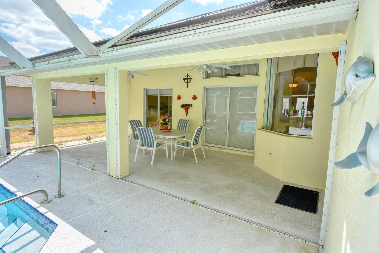 2041 Southwest Villanova Road Port St. Lucie, FL 34953 - Photo 34 of 42 a view of a hallway with dining area and glass door