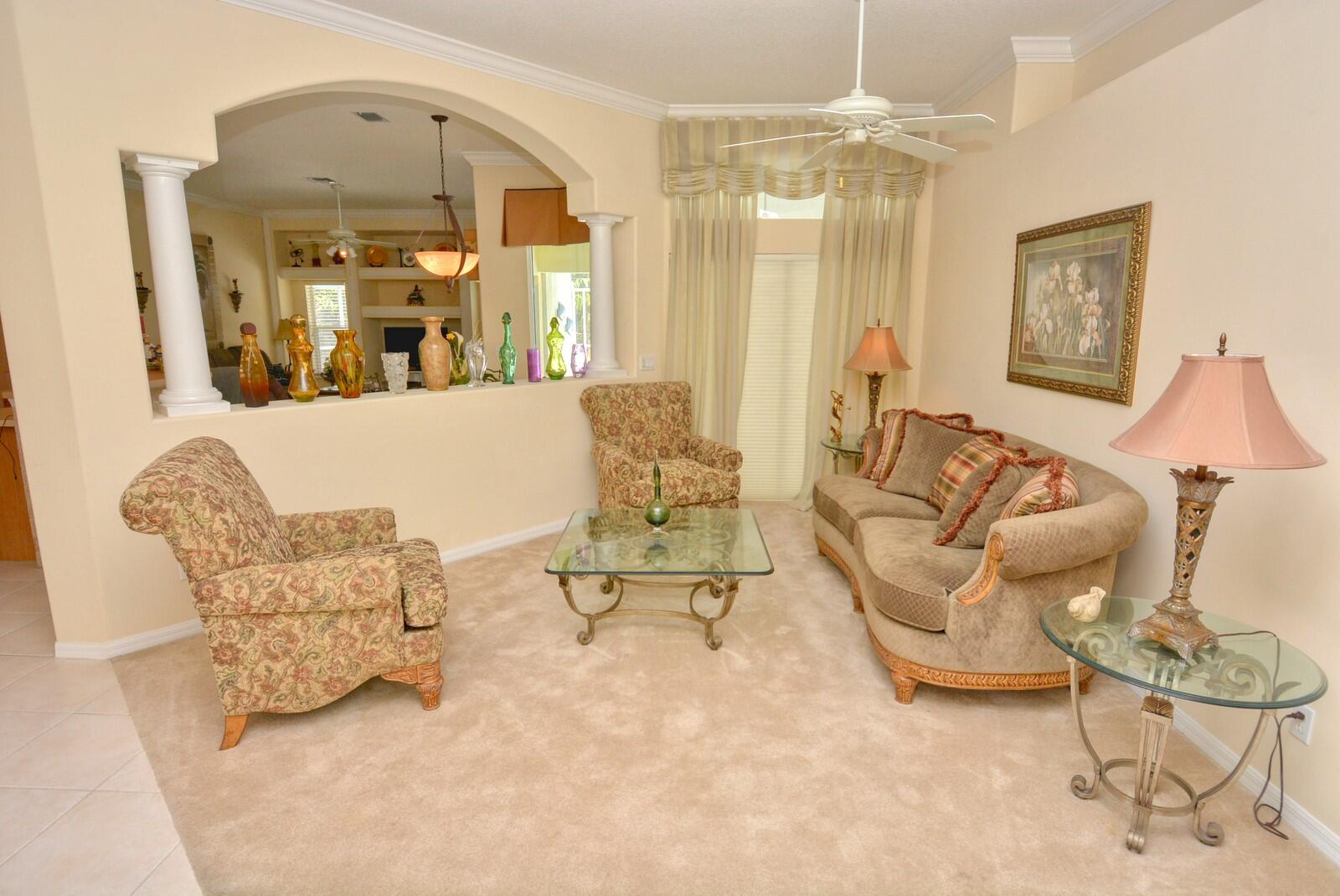 2041 Southwest Villanova Road Port St. Lucie, FL 34953 - Photo 7 of 42 a living room with furniture and a chandelier