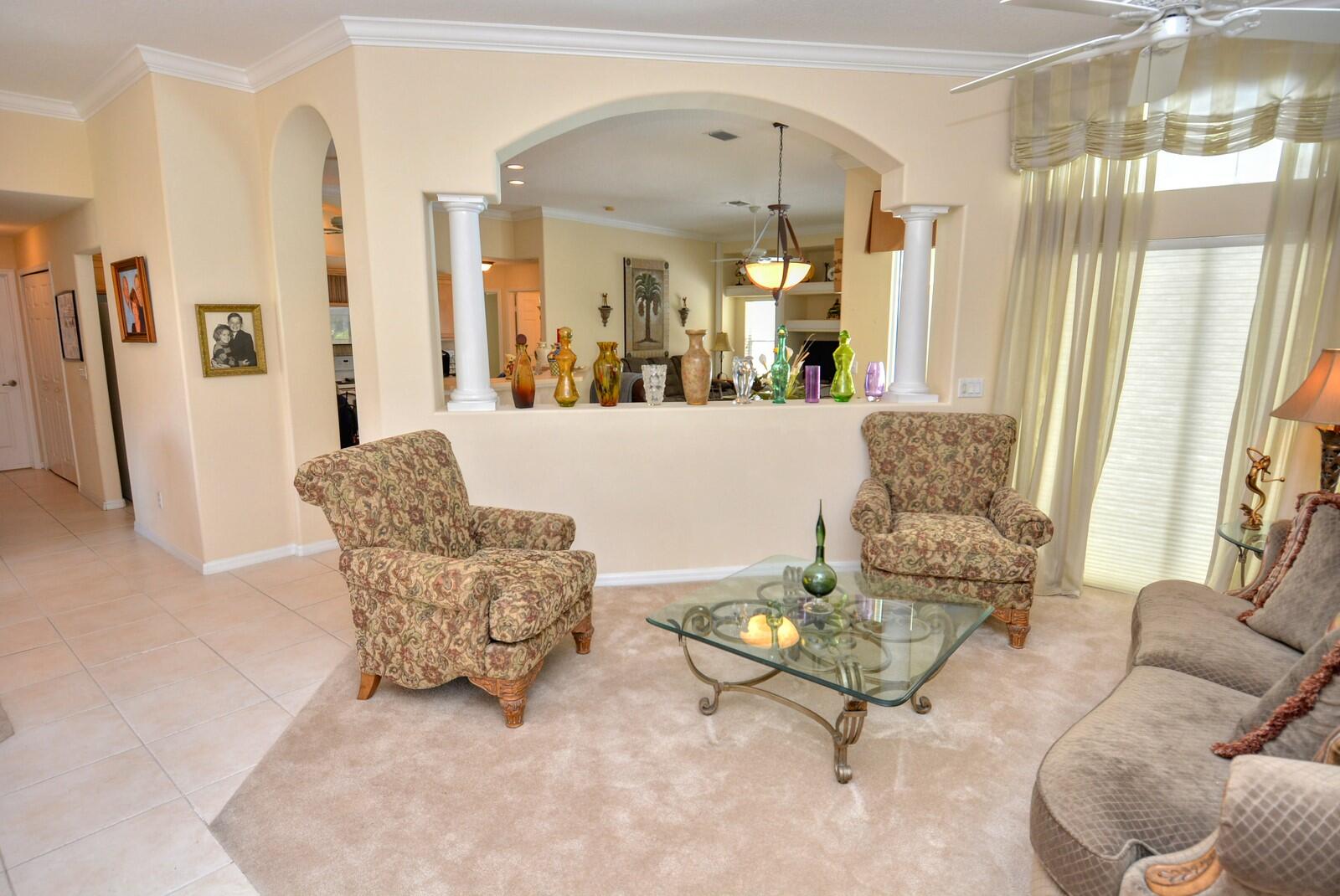 2041 Southwest Villanova Road Port St. Lucie, FL 34953 - Photo 8 of 42 a living room with furniture and a large mirror