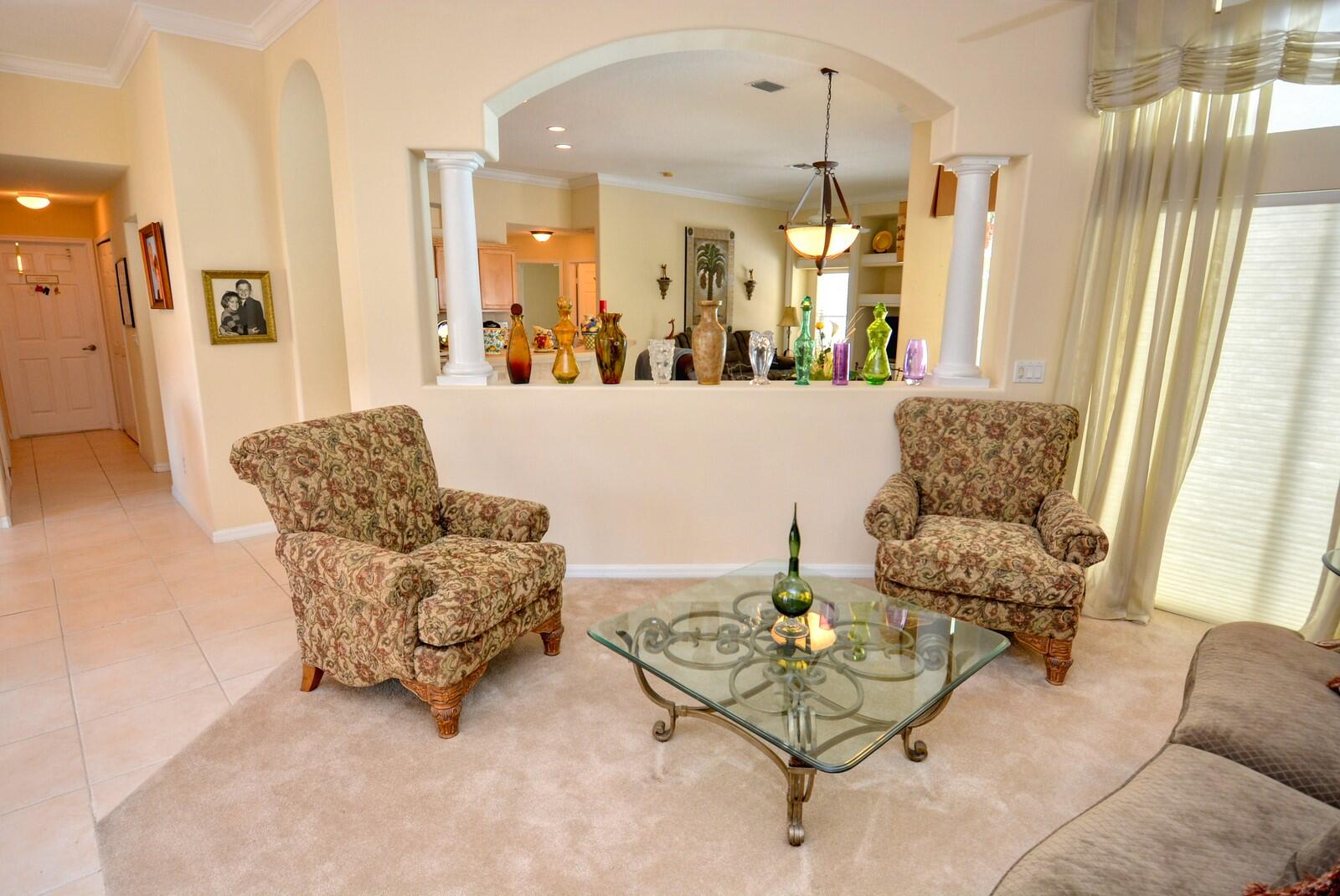 2041 Southwest Villanova Road Port St. Lucie, FL 34953 - Photo 9 of 42 a living room with furniture and a chandelier
