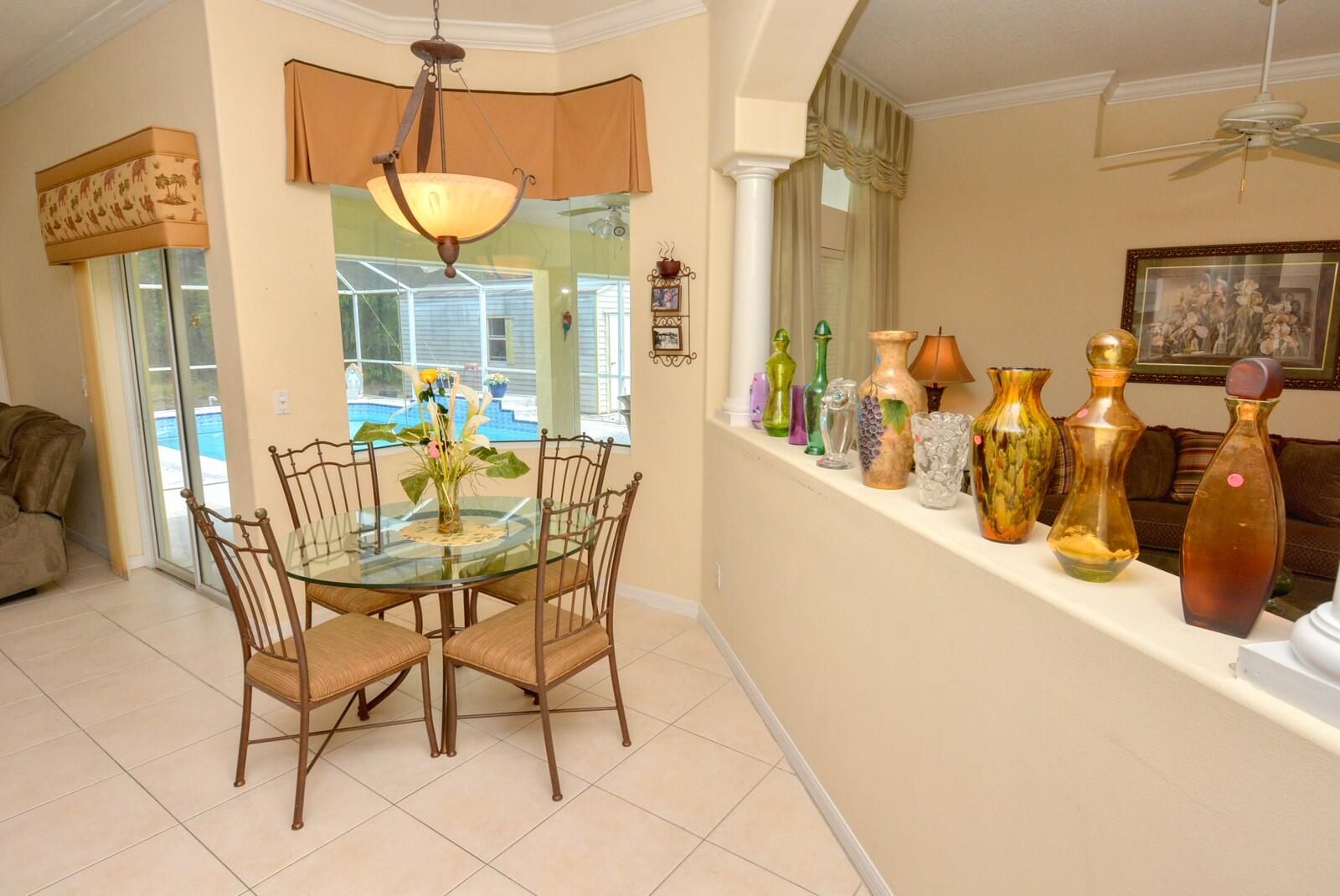 2041 Southwest Villanova Road Port St. Lucie, FL 34953 - Photo 10 of 42 a dining room with furniture and a large window