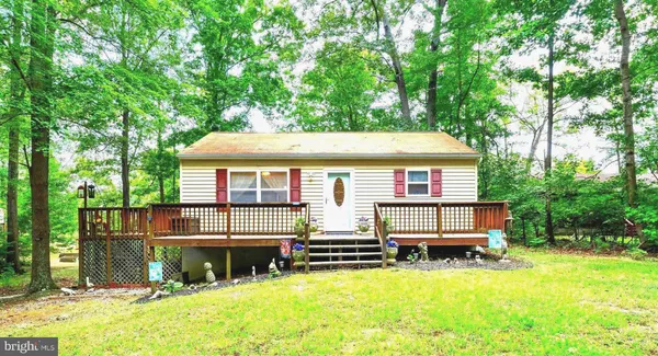 a front view of a house with a yard table and chairs