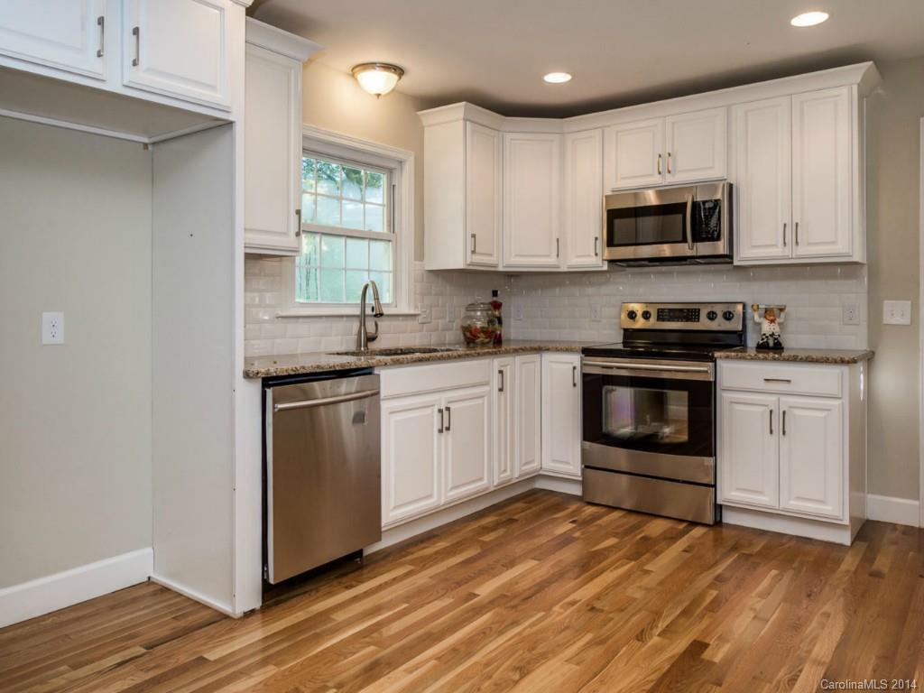 5600 Londonderry Road Charlotte, NC 28210 - Photo 5 of 15 a kitchen with granite countertop white cabinets and white appliances