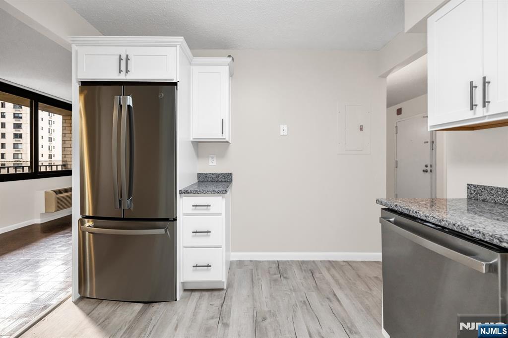 326 Prospect Avenue, Unit 6J Hackensack, NJ 07601 - Photo 4 of 18 a kitchen with a refrigerator and a sink
