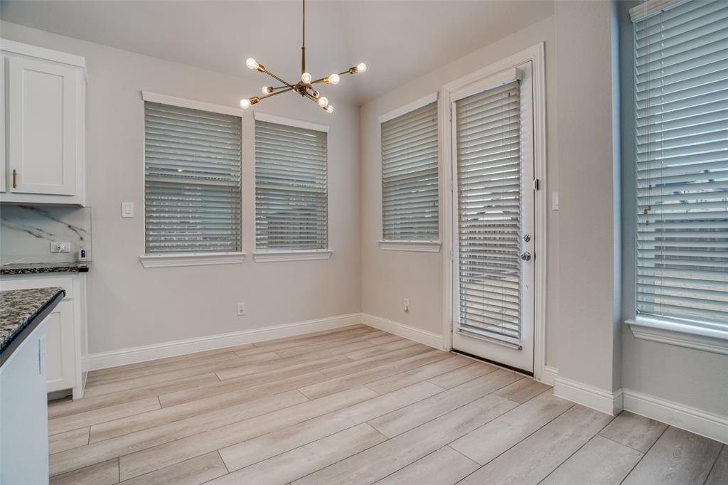 2811 Killdeer Trail Prosper, TX 75078 - Photo 12 of 36 Unfurnished dining area featuring a chandelier and light wood-style floors