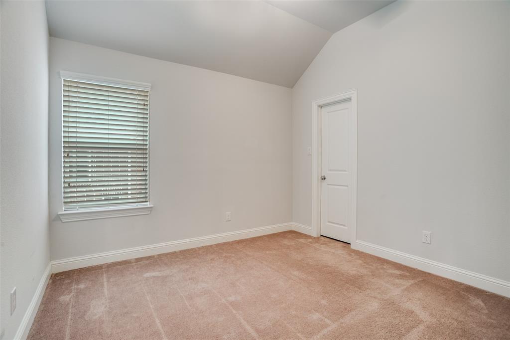 2811 Killdeer Trail Prosper, TX 75078 - Photo 24 of 36 Empty room with vaulted ceiling and light colored carpet