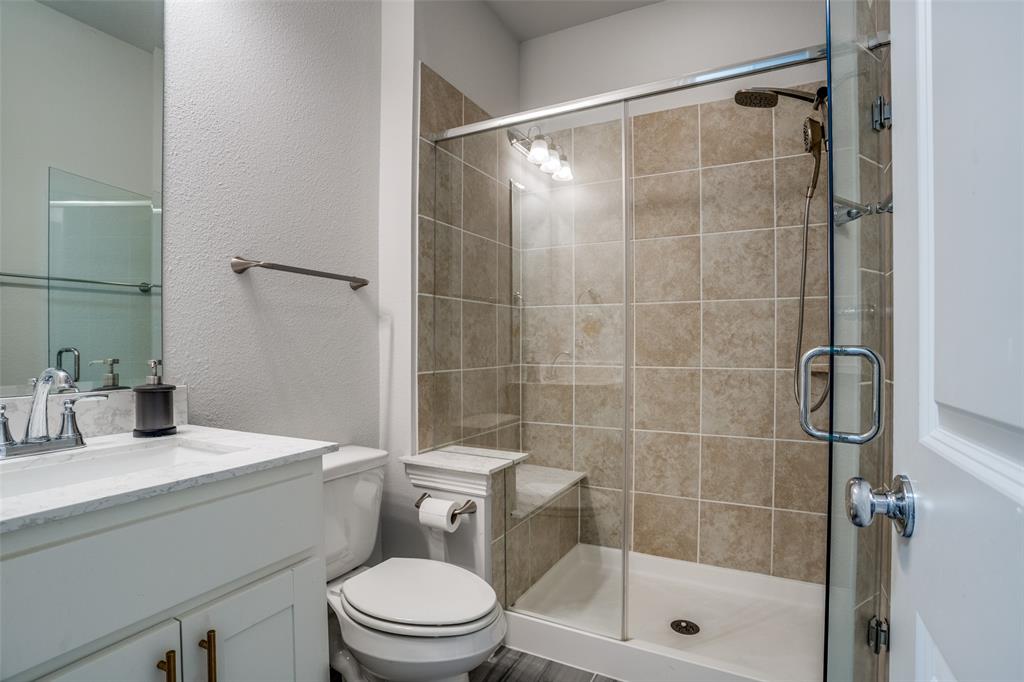 2811 Killdeer Trail Prosper, TX 75078 - Photo 27 of 36 Full bathroom featuring a textured wall, vanity, and a shower stall
