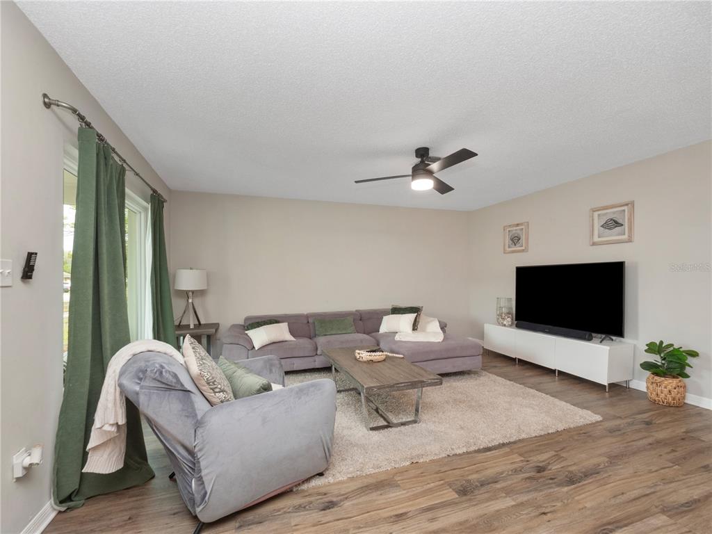 2733 Middle Street Orlando, FL 32807 - Photo 7 of 23 a living room with furniture and a flat screen tv