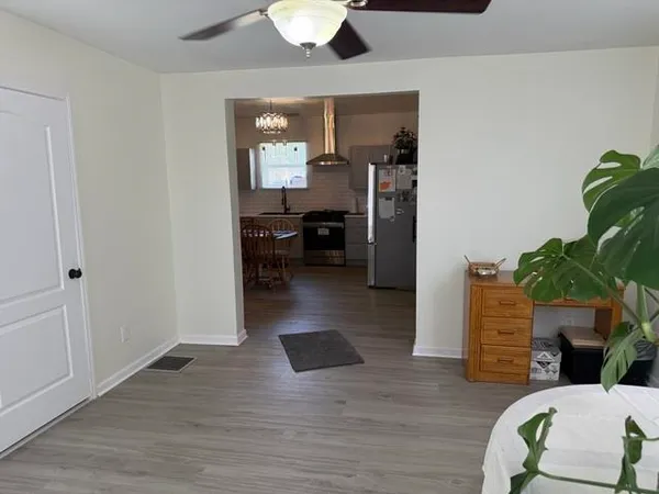 a view of living room filled with furniture and wooden floor