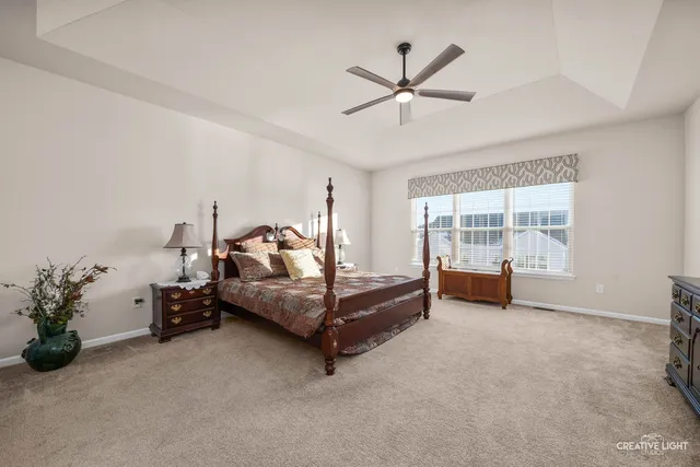 a bedroom with furniture and a ceiling fan