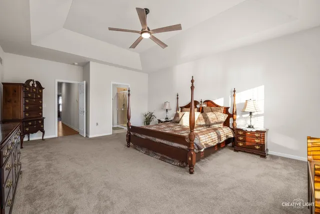 a bathroom with a granite countertop sink two mirror and shower
