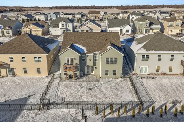 a view of a house with wooden fence
