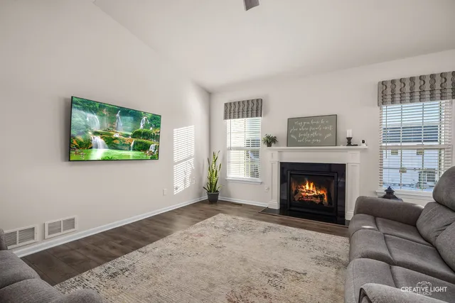 a living room with furniture and a ceiling fan
