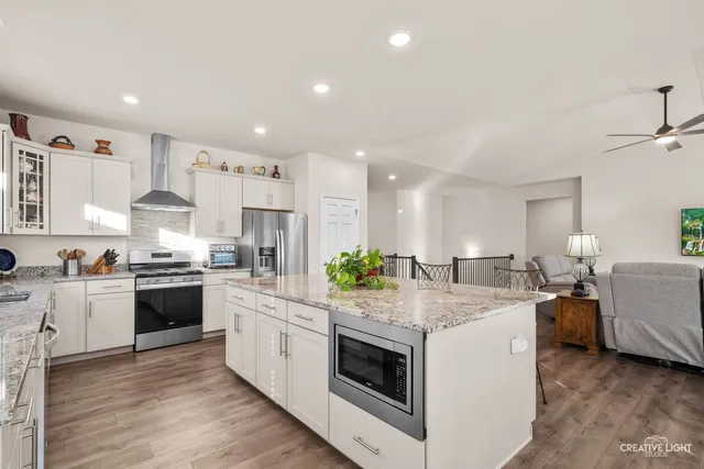 a kitchen with counter top space and living room