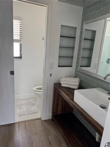 a bathroom with a sink a toilet and shower