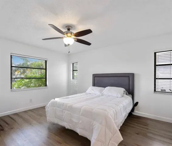 a bedroom with double bed and a window