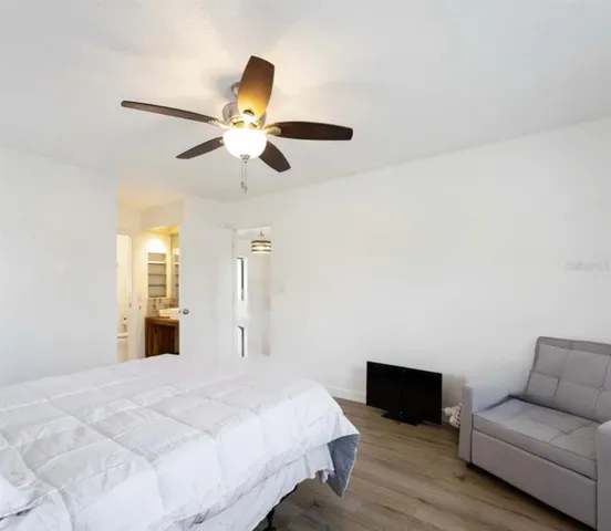 a bedroom with a bed and a couch