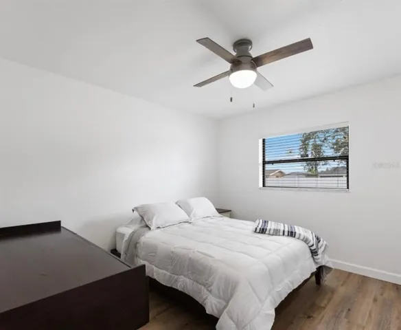 a bedroom with bed and window