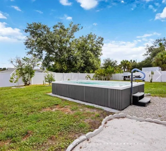 a view of a backyard with a wooden fence