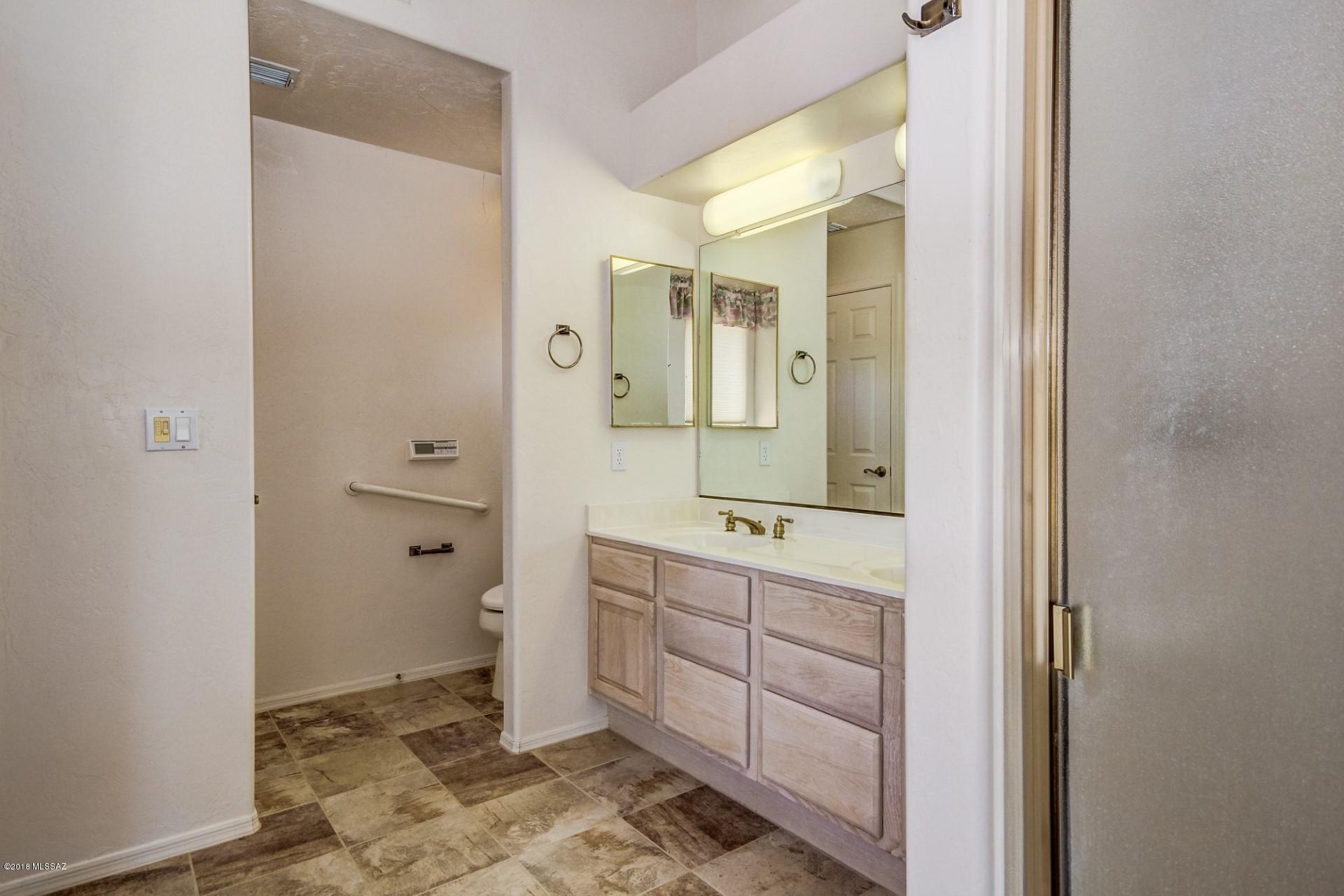 14480 North Swan Road Tucson, AZ 85739 - Photo 19 of 31 a spacious bathroom with a double vanity sink a mirror and a shower