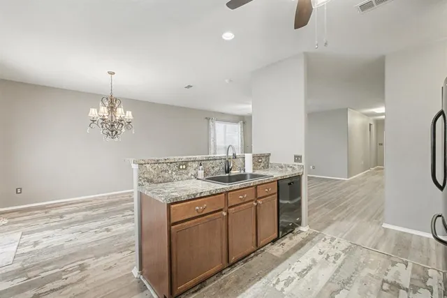a bathroom with a granite countertop sink a toilet and a mirror
