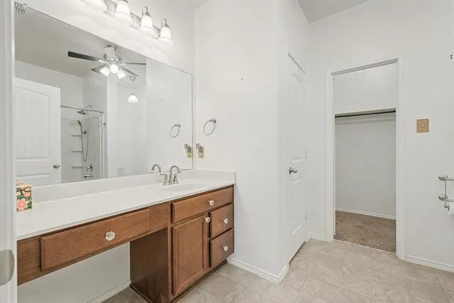 a bathroom with a double vanity sink a mirror and a shower