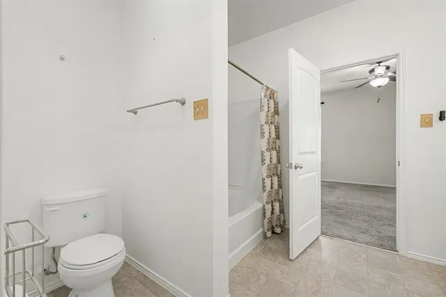 a bathroom with a shower and a toilet