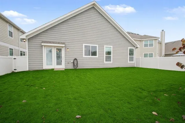 a view of a house with a backyard