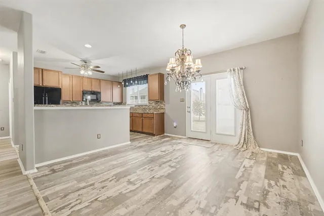 a view of a kitchen with microwave and cabinets