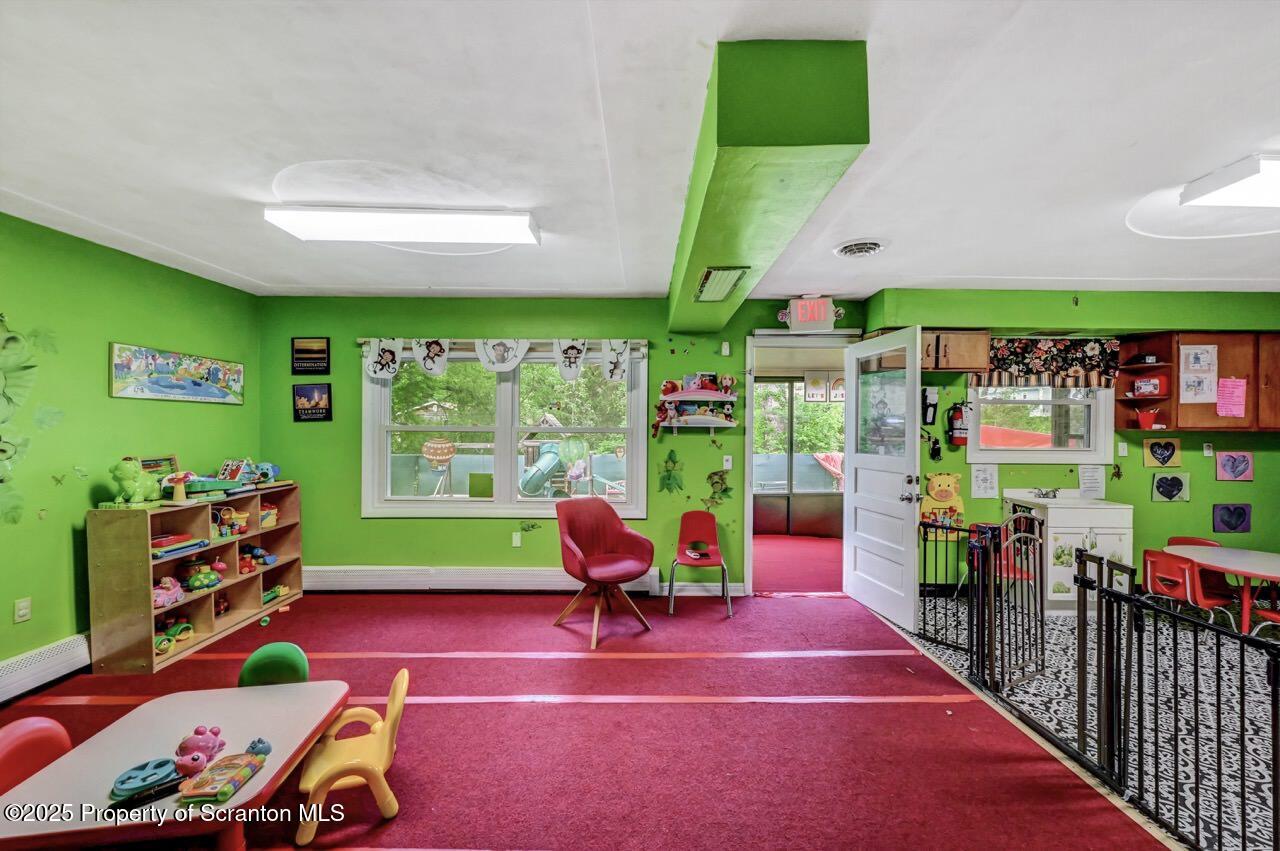 2118 Washburn Street Scranton, PA 18504 - Photo 12 of 72 a living room with a soccer table and a flat screen tv