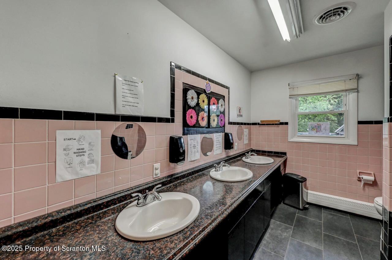 2118 Washburn Street Scranton, PA 18504 - Photo 28 of 72 a bathroom with a granite countertop sink a toilet and a mirror
