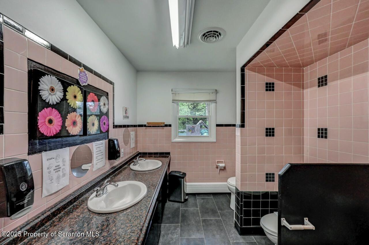 2118 Washburn Street Scranton, PA 18504 - Photo 29 of 72 a bathroom with a toilet a sink and a shower