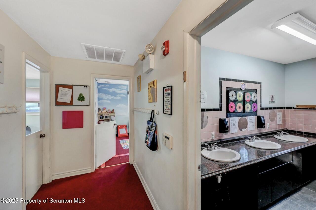 2118 Washburn Street Scranton, PA 18504 - Photo 33 of 72 a view of kitchen island with stainless steel appliances furniture stove top oven and cabinets