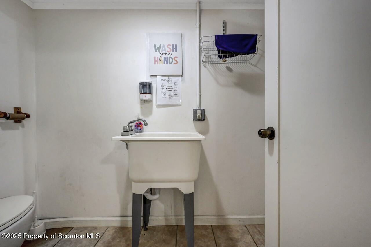 2118 Washburn Street Scranton, PA 18504 - Photo 45 of 72 a bathroom with a sink toilet and vanity