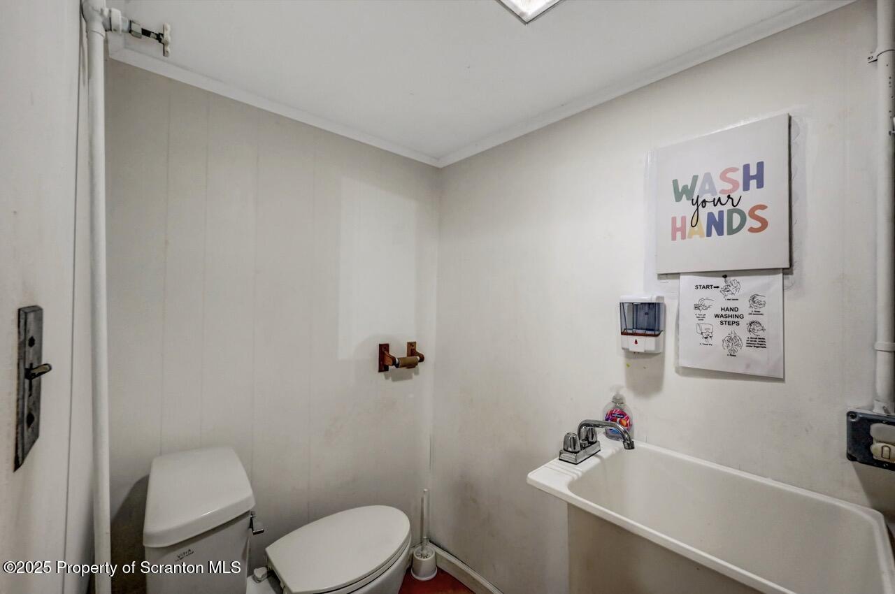 2118 Washburn Street Scranton, PA 18504 - Photo 46 of 72 a white toilet sitting next to a bathroom sink