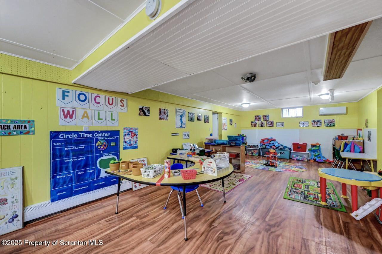 2118 Washburn Street Scranton, PA 18504 - Photo 48 of 72 a living room with furniture a rug and a bookshelf