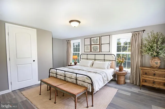 a bedroom with a bed and a large window