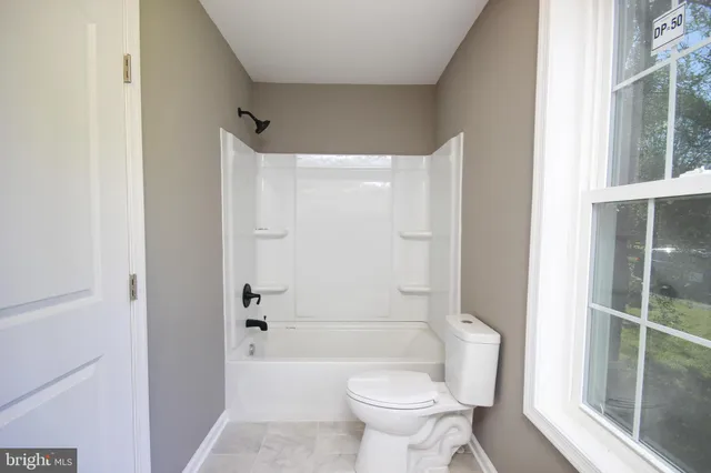 a bathroom with a toilet and a bathtub