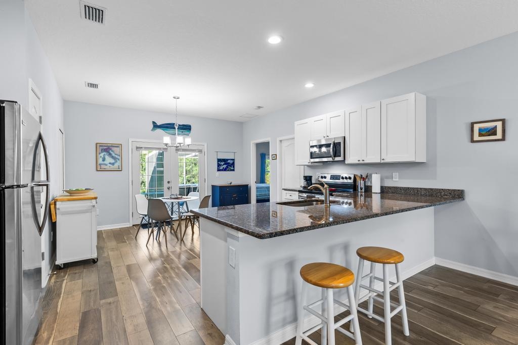 124 Dory Road St. Augustine, FL 32086 - Photo 11 of 39 a kitchen with granite countertop lots of counter top space and stainless steel appliances