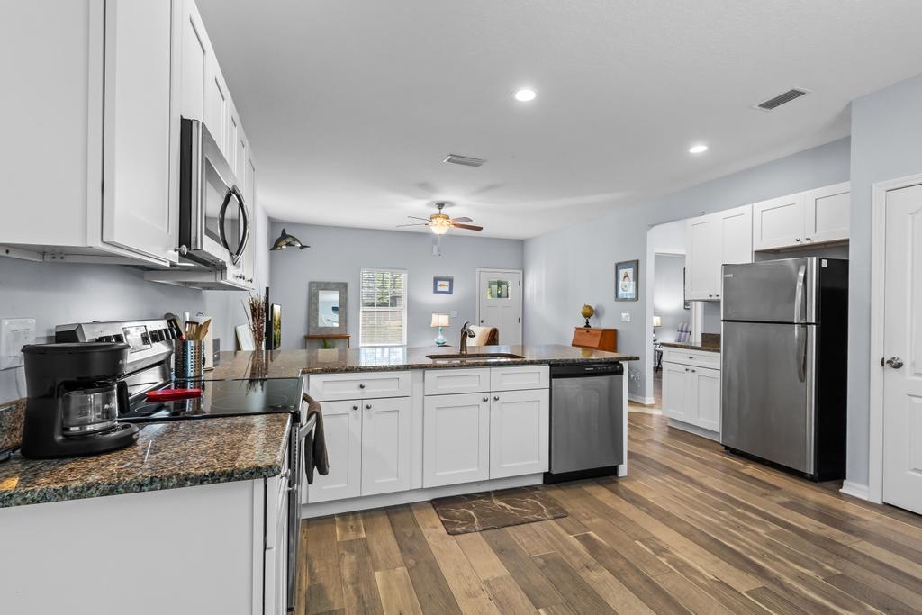 124 Dory Road St. Augustine, FL 32086 - Photo 16 of 39 a kitchen with refrigerator and cabinets
