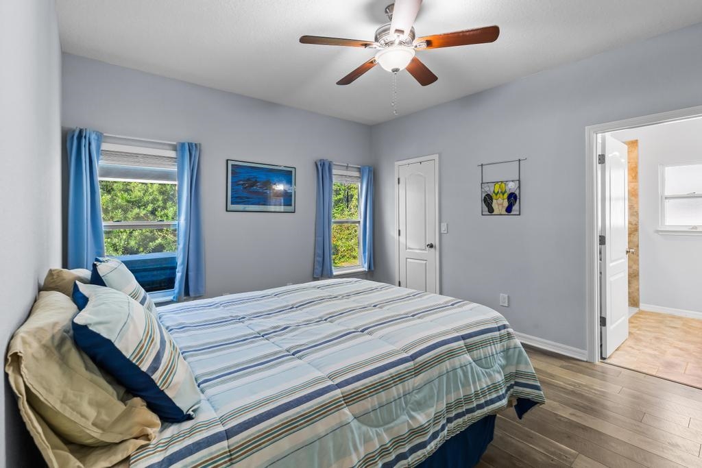 124 Dory Road St. Augustine, FL 32086 - Photo 17 of 39 a bedroom with a bed and wooden floor